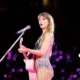 BREAKING NEWS: Taylor Swift dressed in a beautiful Stunning sparkling dress with her pink guitar sending fans into frenzy causing commotion as fans screamed Calling Her Barbie Tay