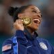 Simone Biles of Team United States celebrates on the podium during the medal ceremony for the Artistic Gymnastics Women